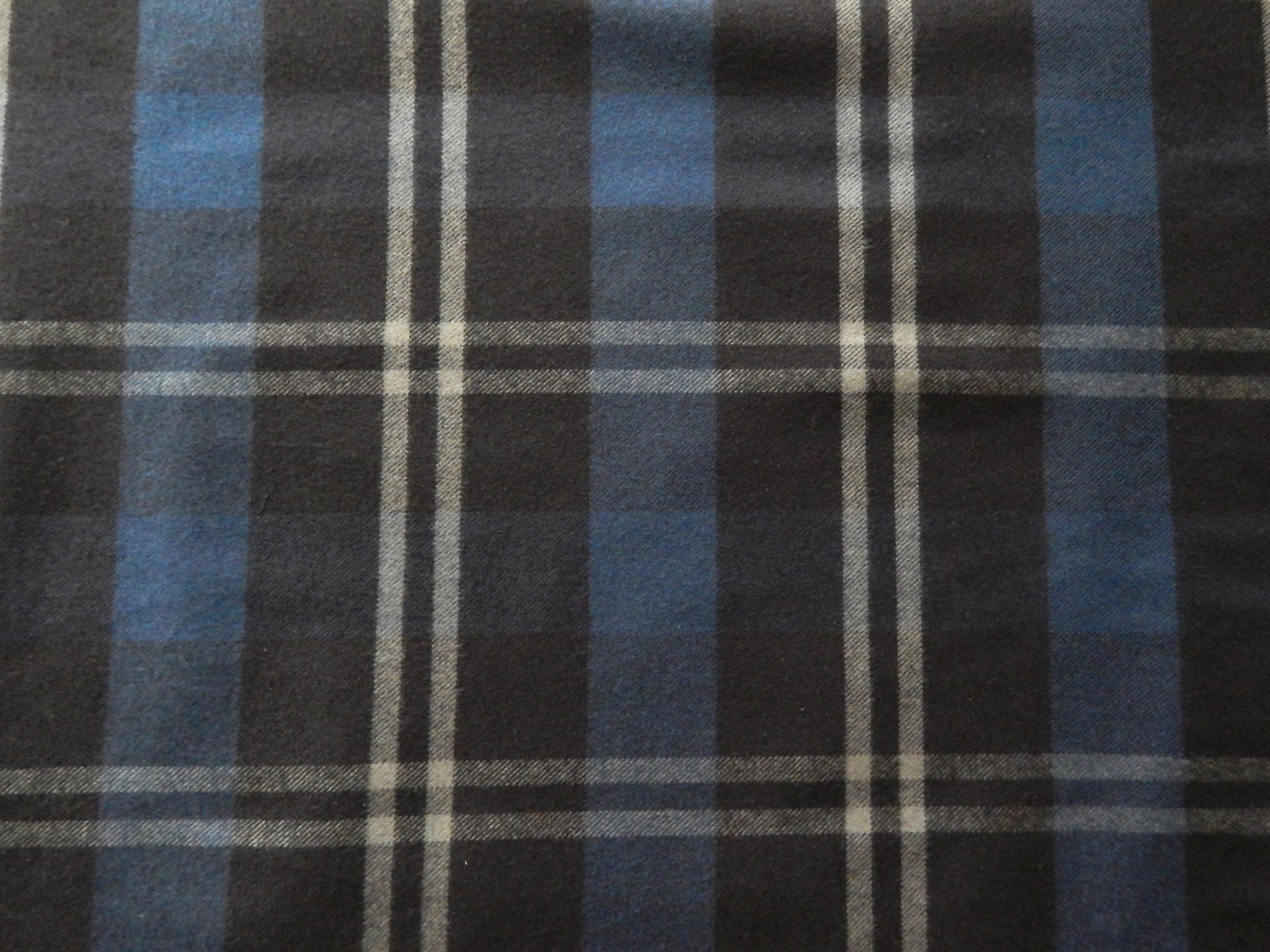 Black, grey, and blue plaid fabric