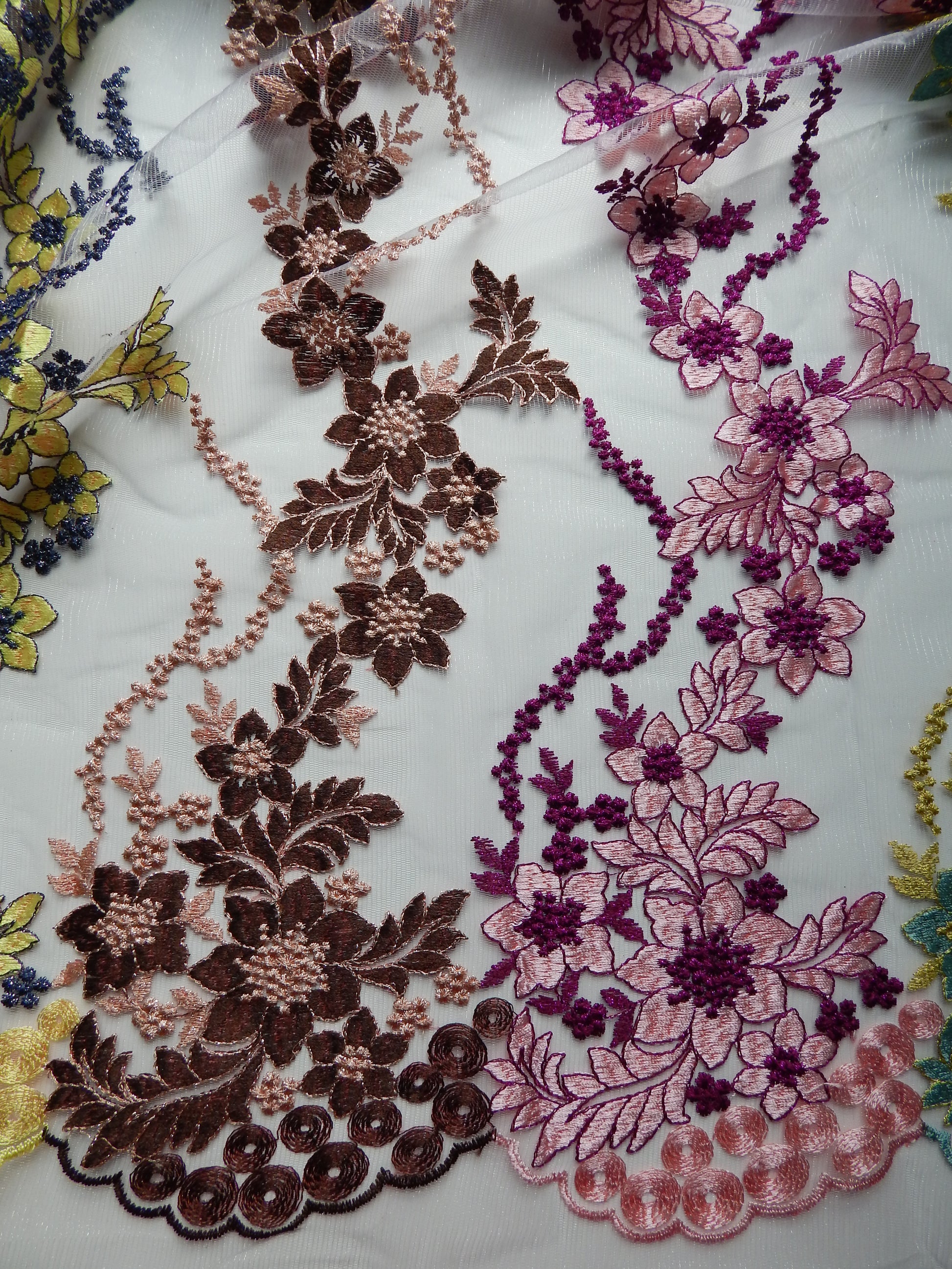 brown, purple, and pink lace fabric