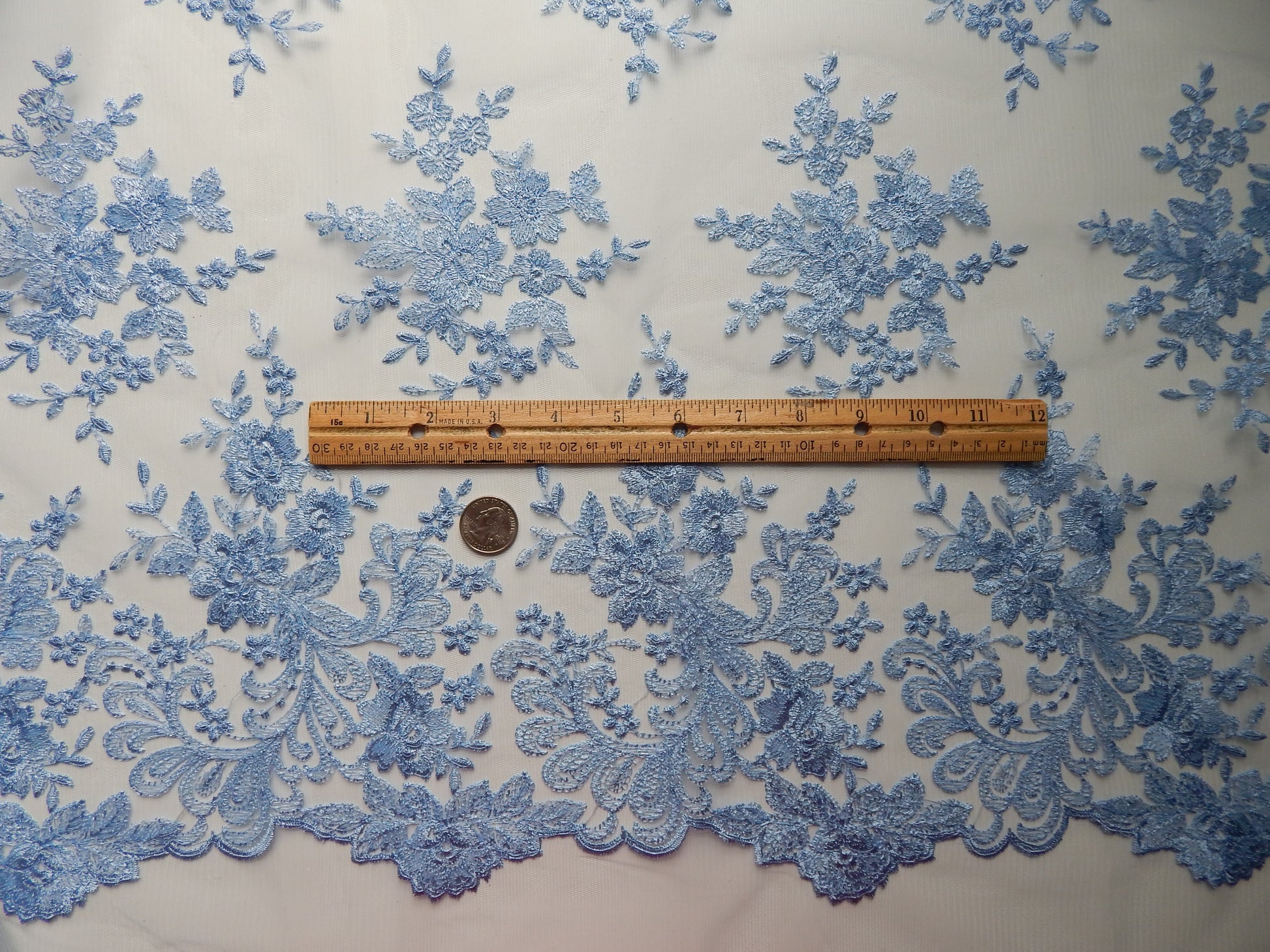 Blue scalloped lace fabric