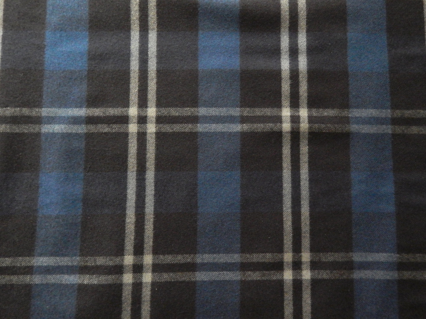 Black, grey, and blue plaid fabric