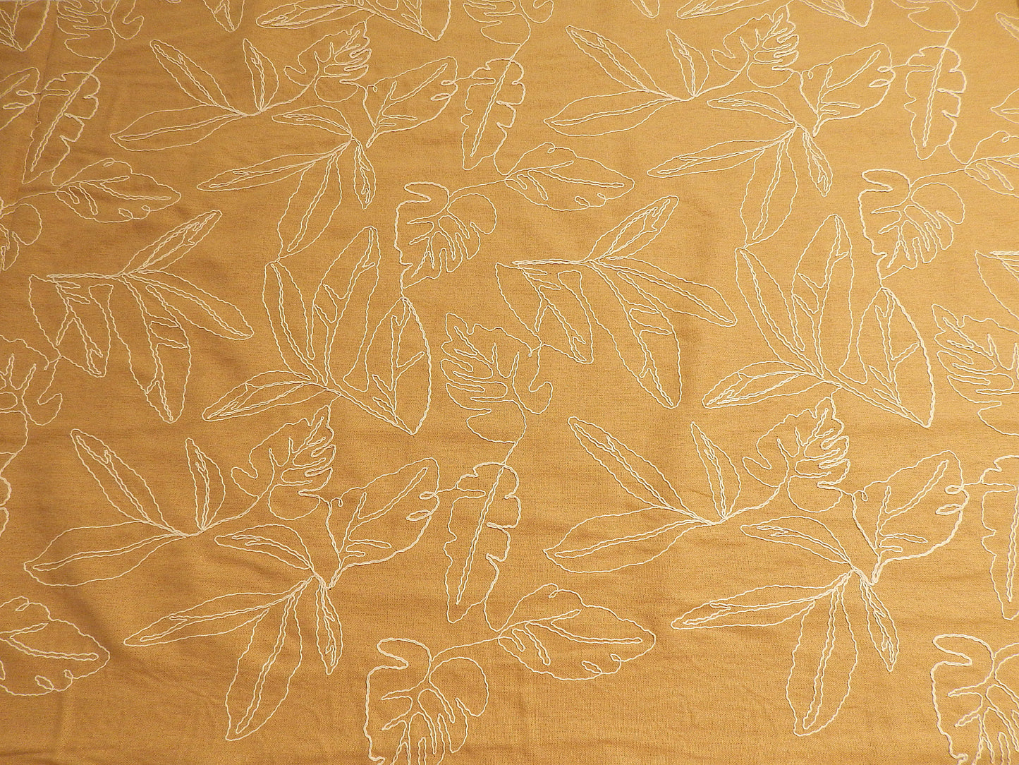 mustard yellow tan and natural monstera leaf couched linen and rayon blend telio fabric