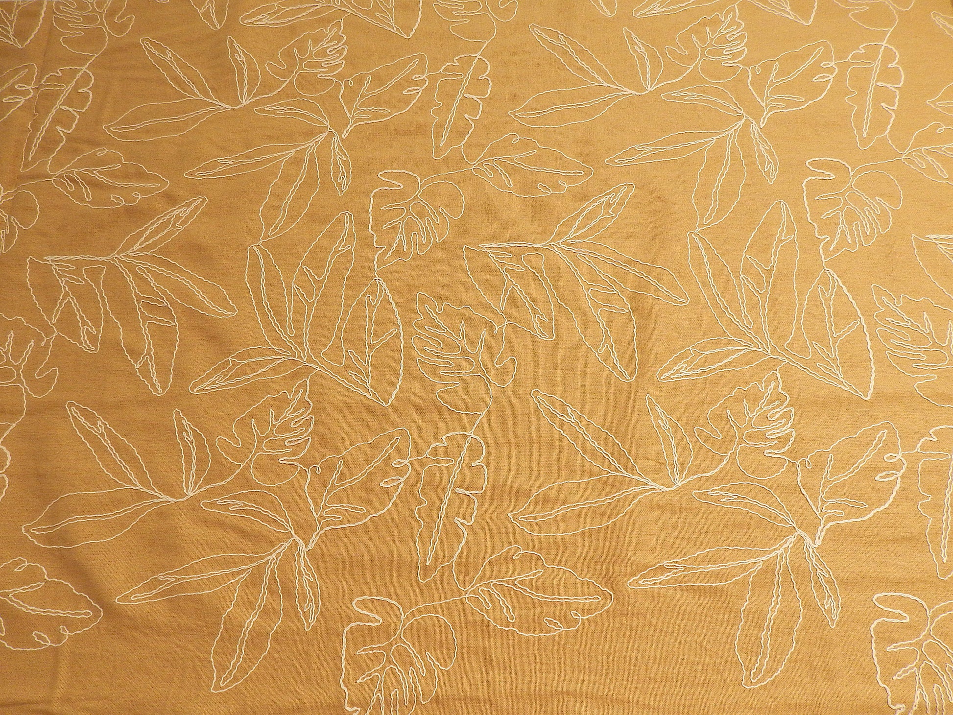 mustard yellow tan and natural monstera leaf couched linen and rayon blend telio fabric