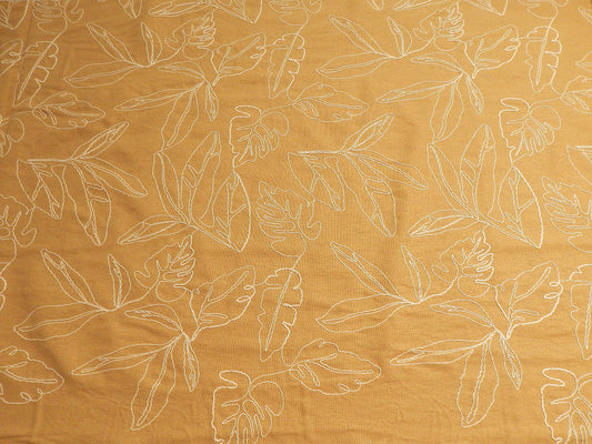 mustard yellow tan and natural monstera leaf couched linen and rayon blend telio fabric