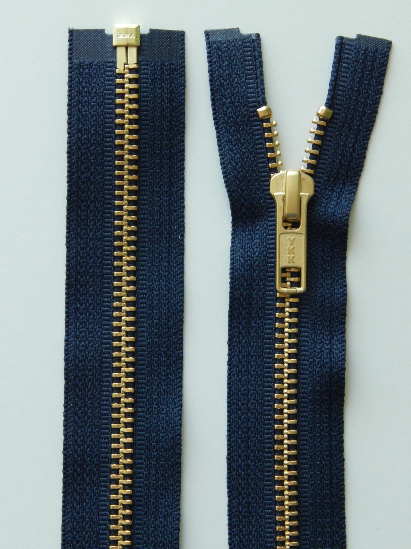 dark blue and brass gold separating jacket zippers
