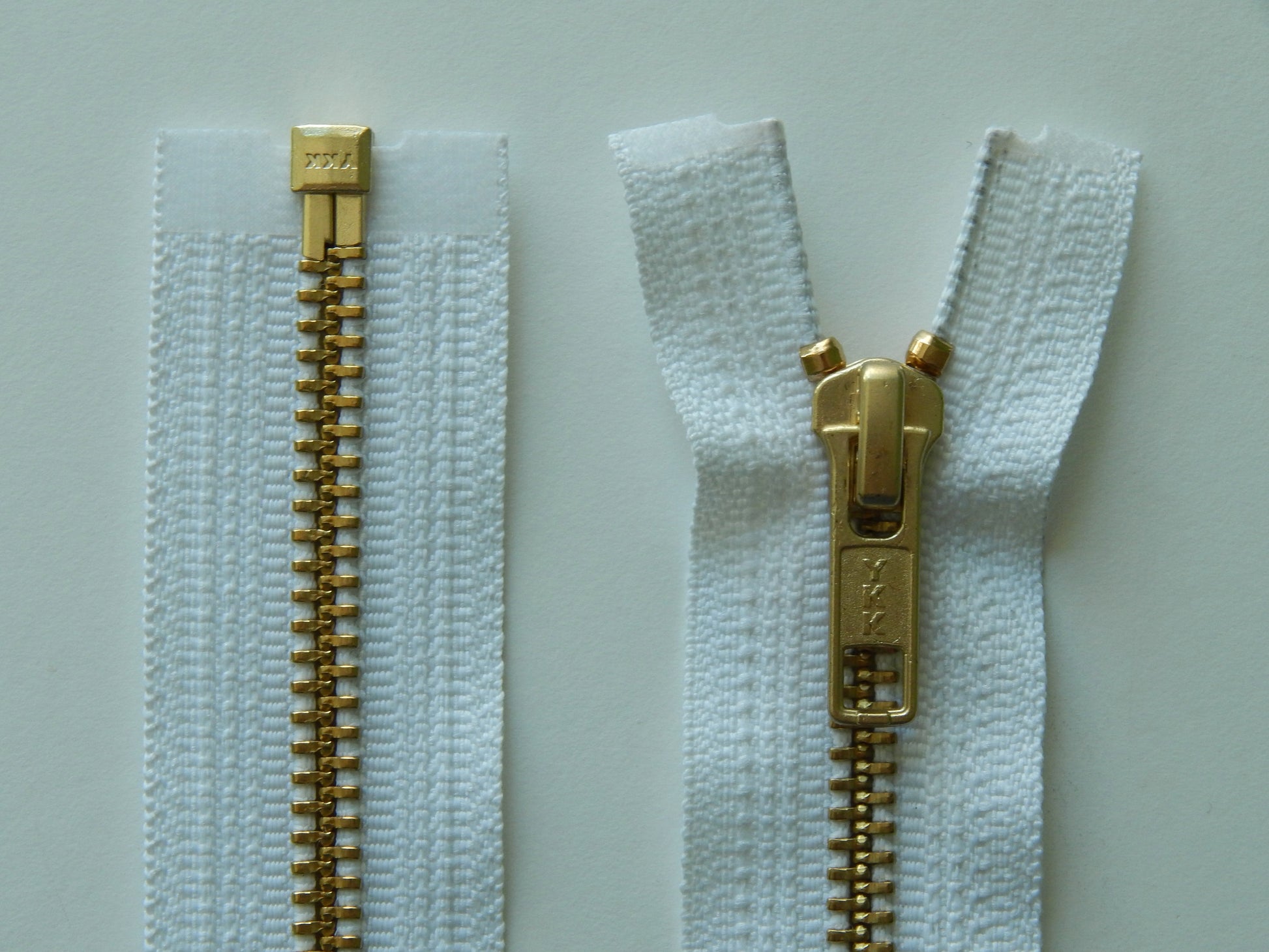 white and brass jacket zippers