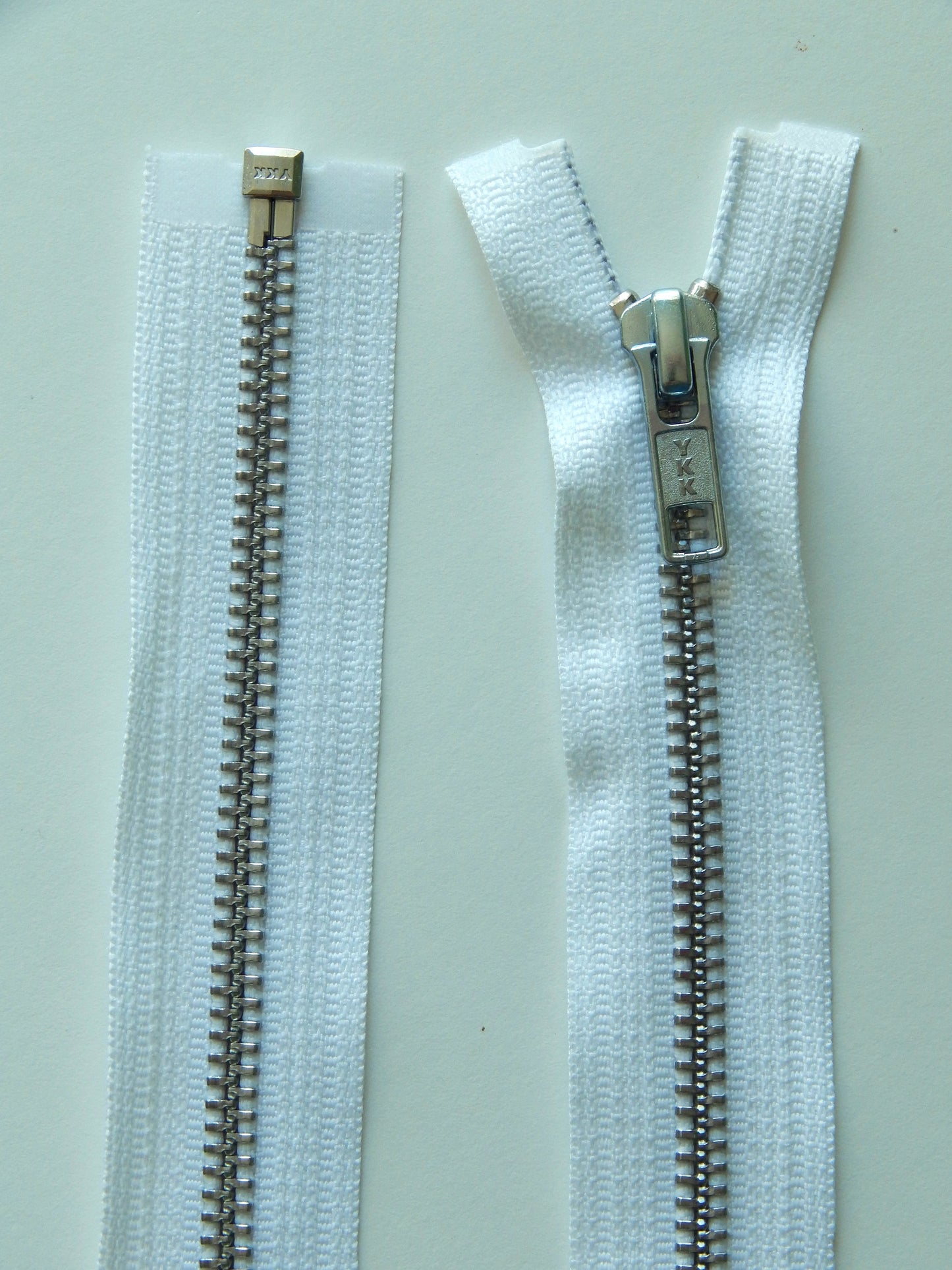 white and aluminum separating zipper