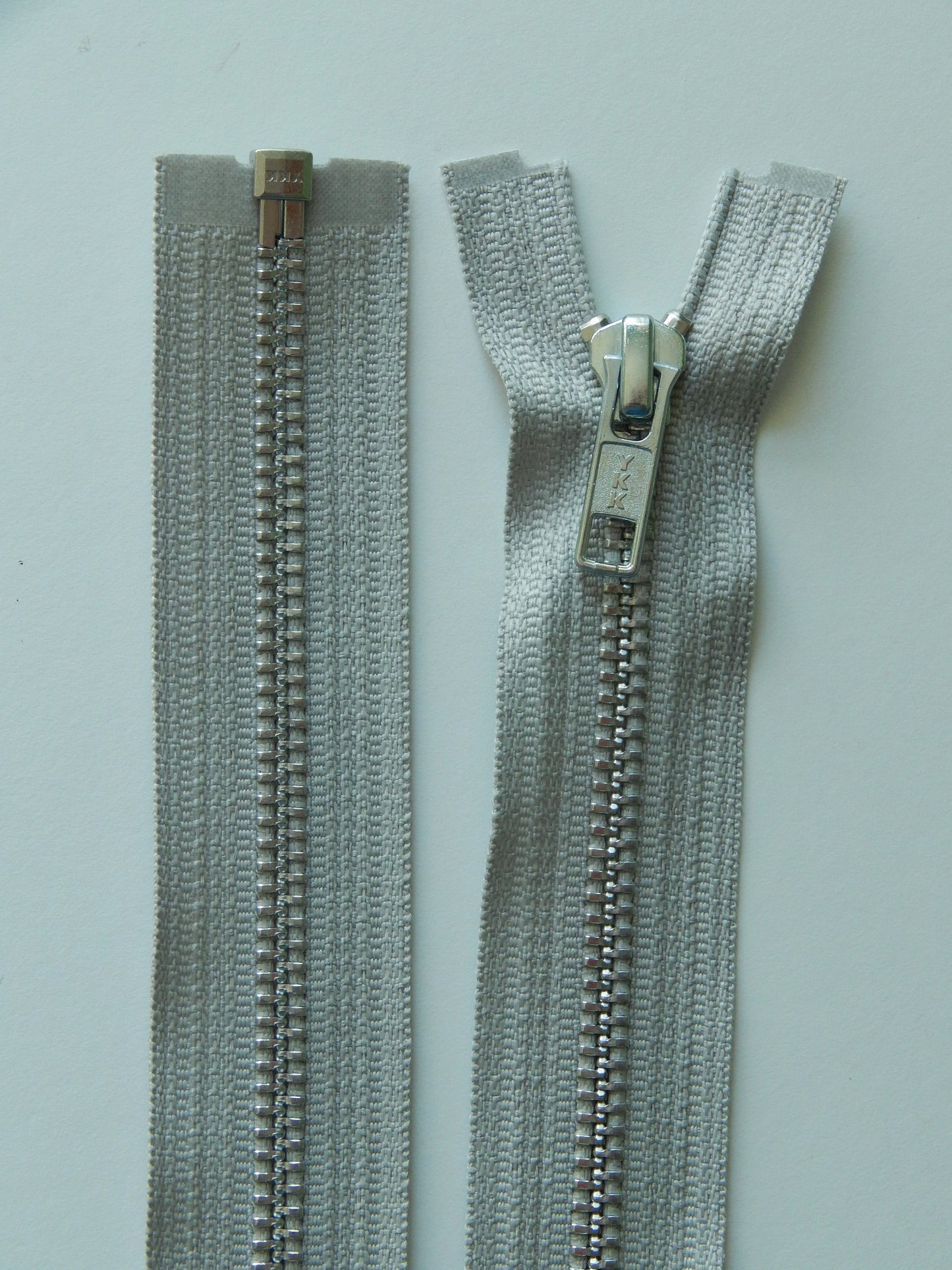 light gray and aluminum separating zipper