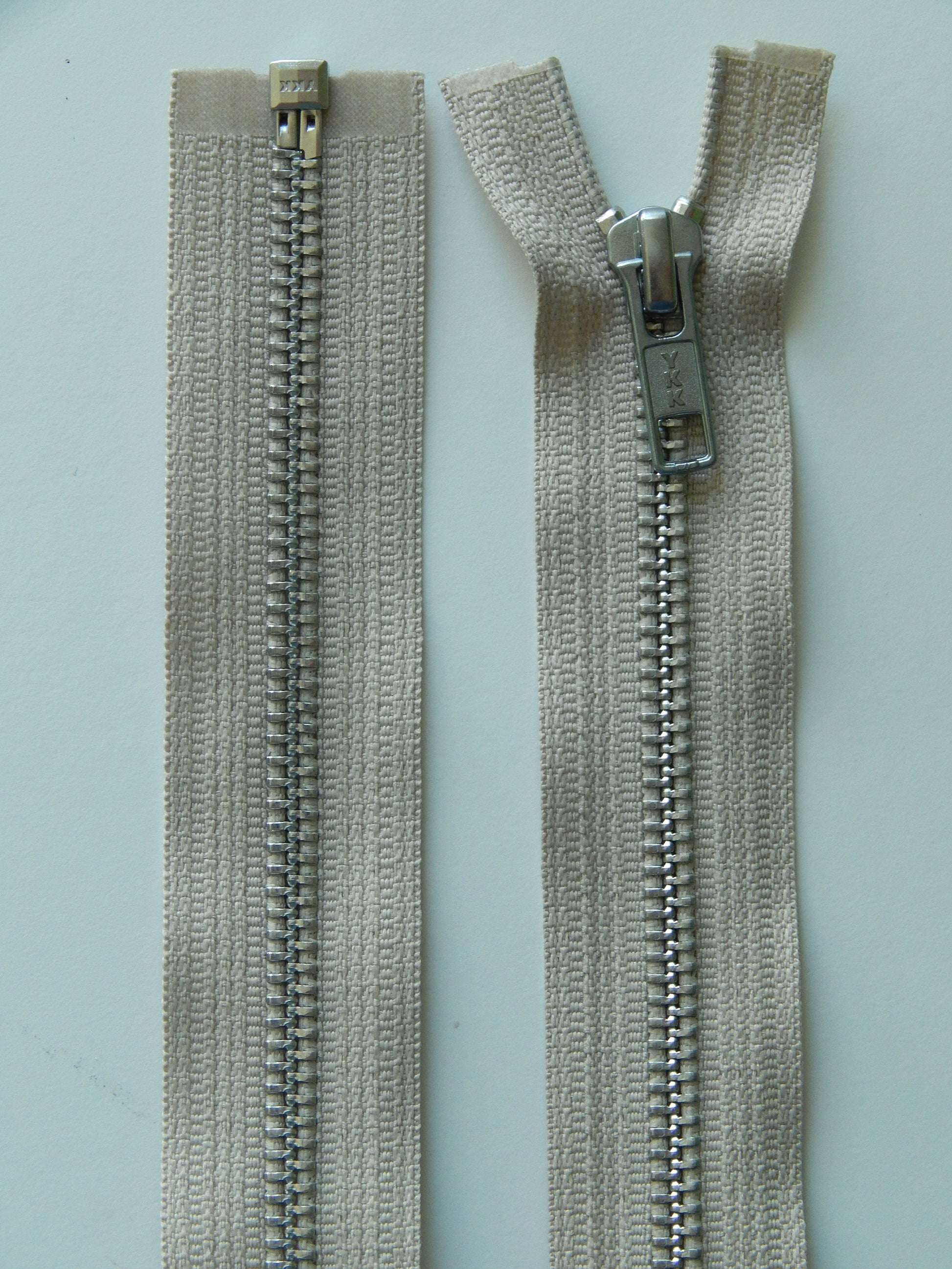 beige and aluminum separating zipper