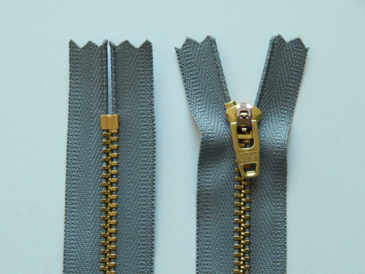 grey and brass nonseparating zipper