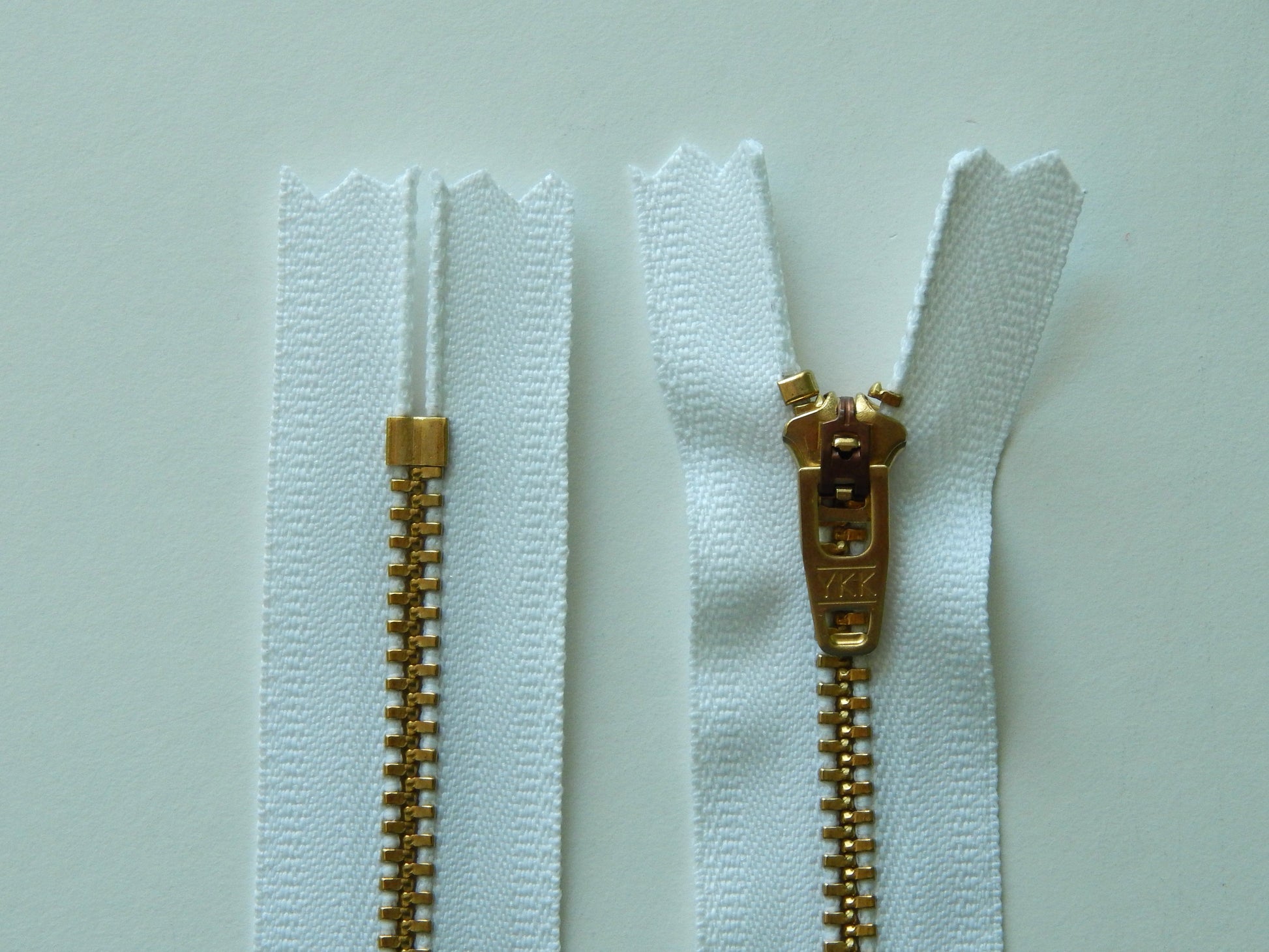 white and brass pant zipper