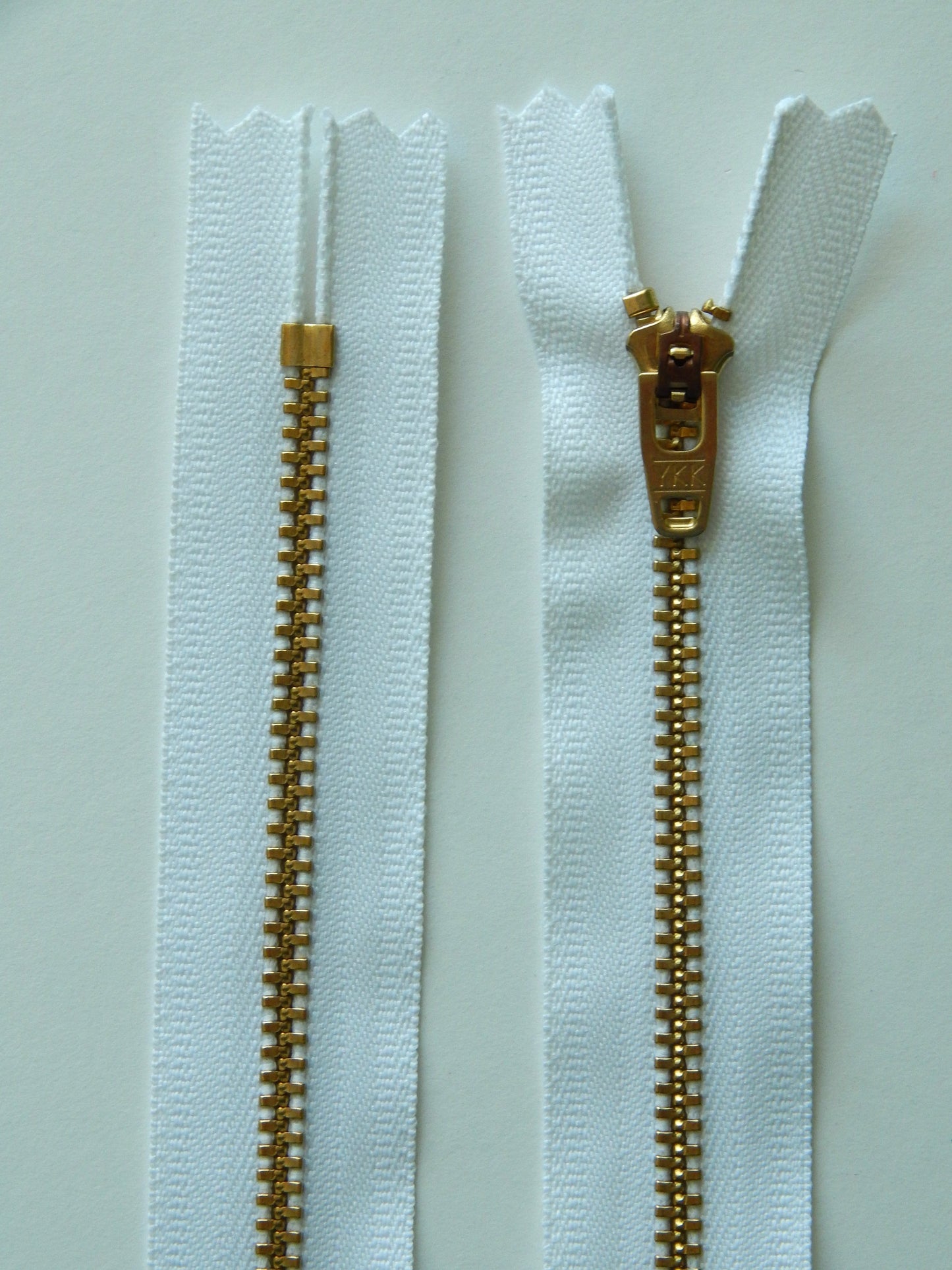 white and brass gold nonseparating pant zipper