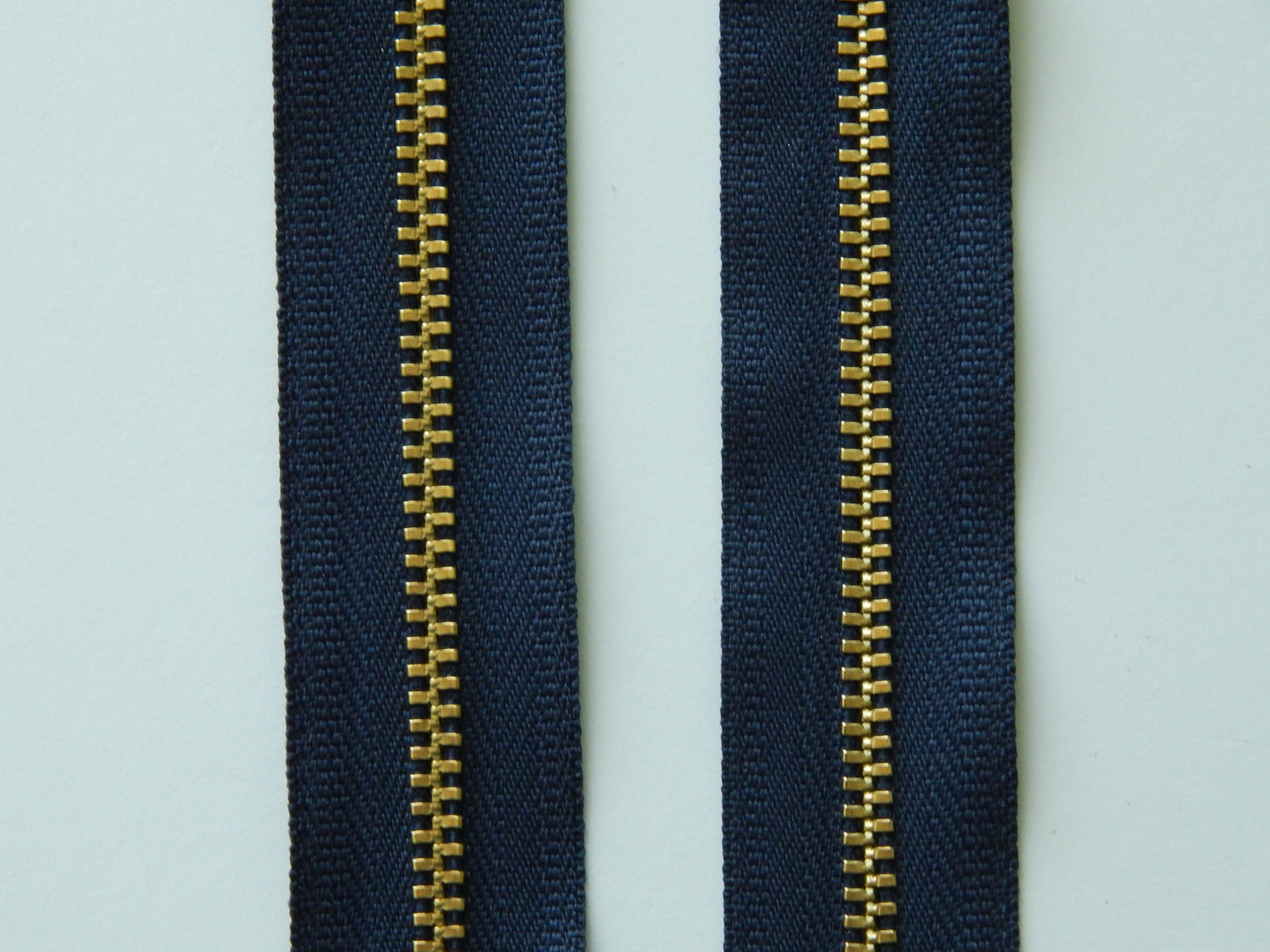 navy blue and gold zipper