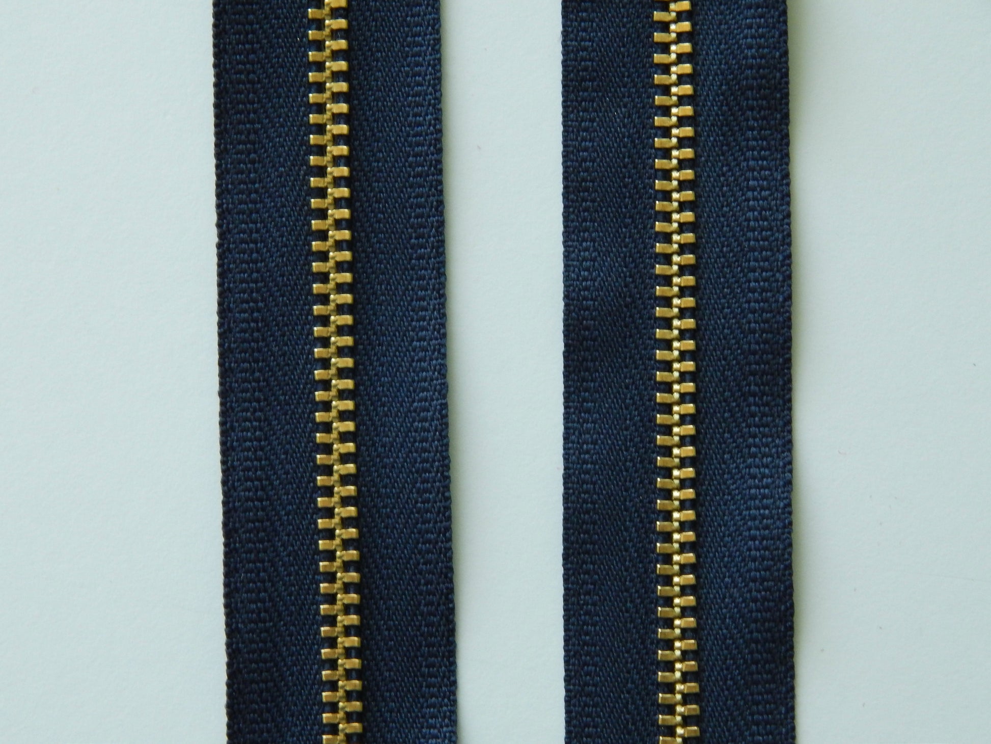 navy blue and gold zipper