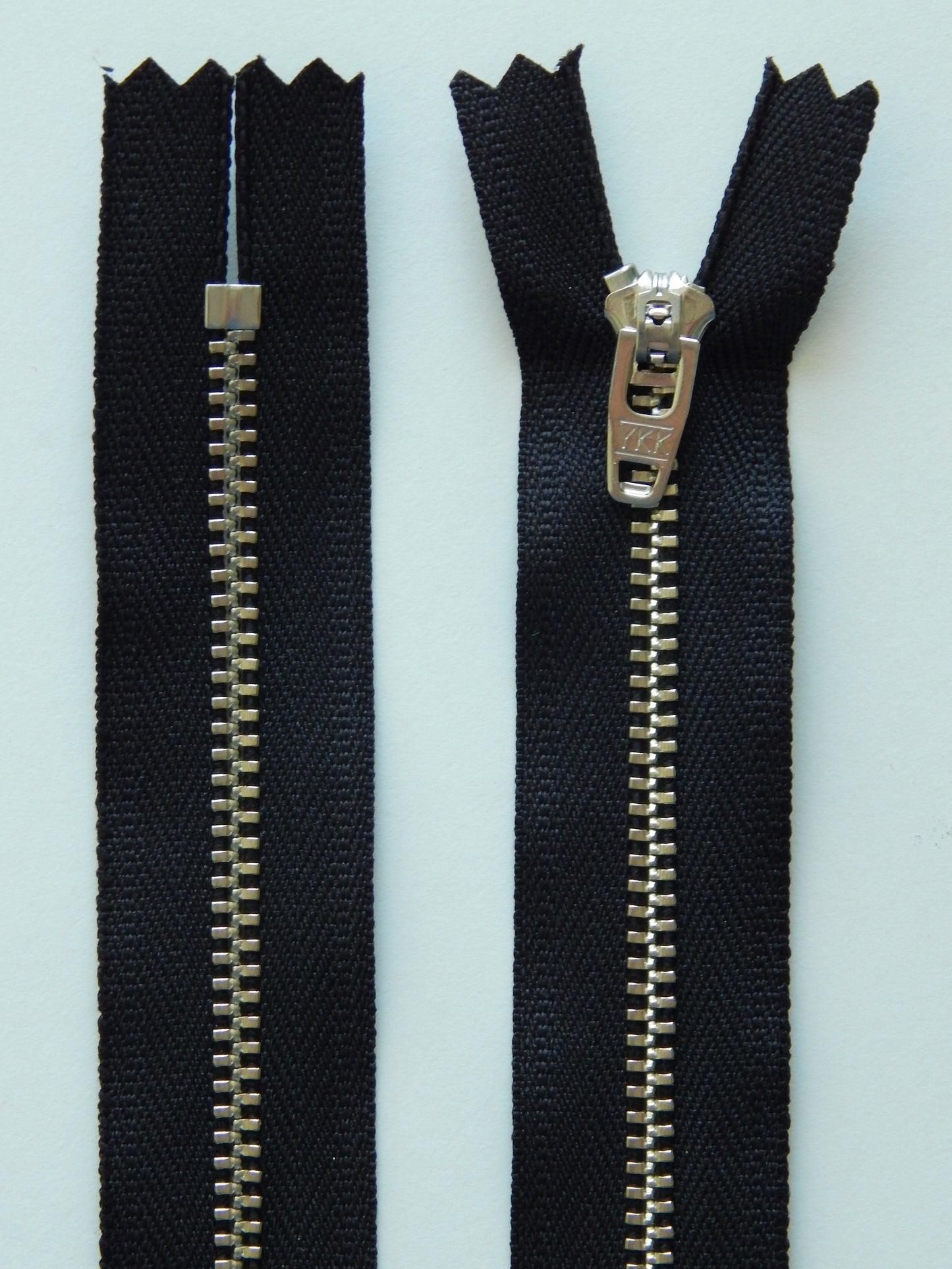 black and silver metal nonseparating pant zipper