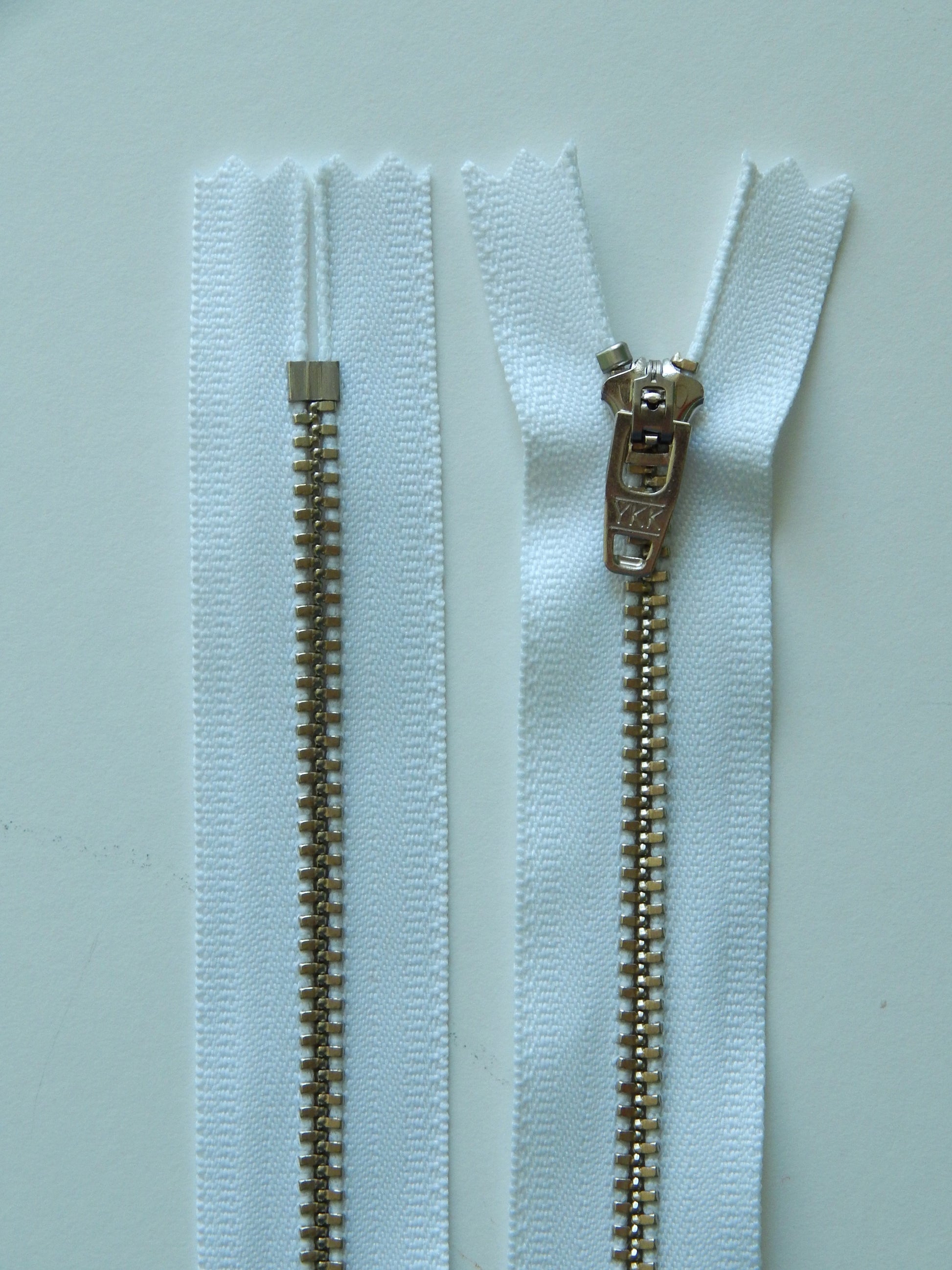 white and silver metal nonseparating pant zipper