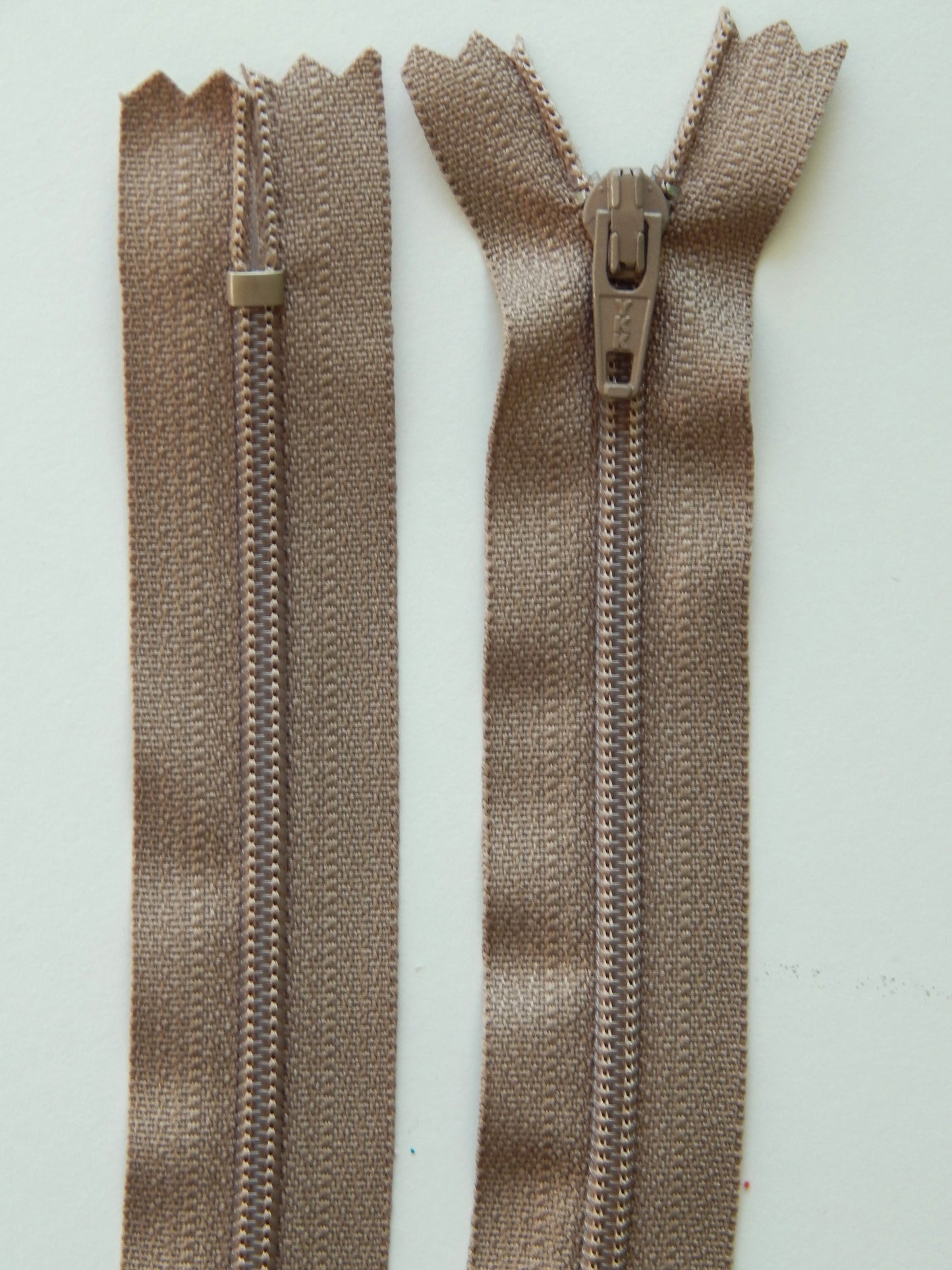dark tan plastic nonseparating skirt zipper