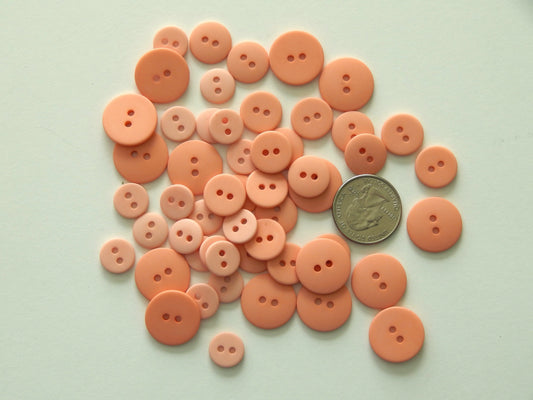 peach plastic buttons