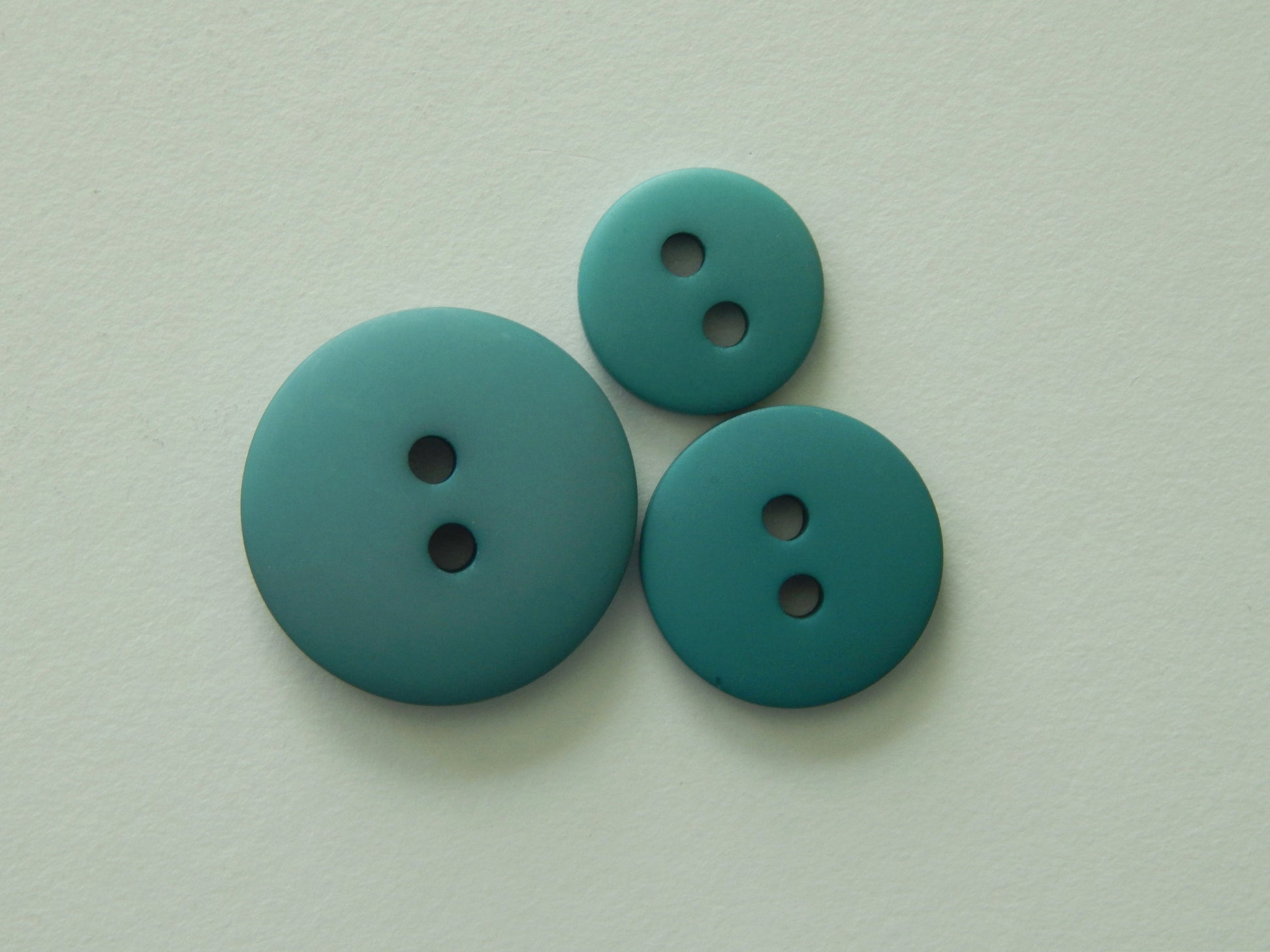 teal plastic buttons