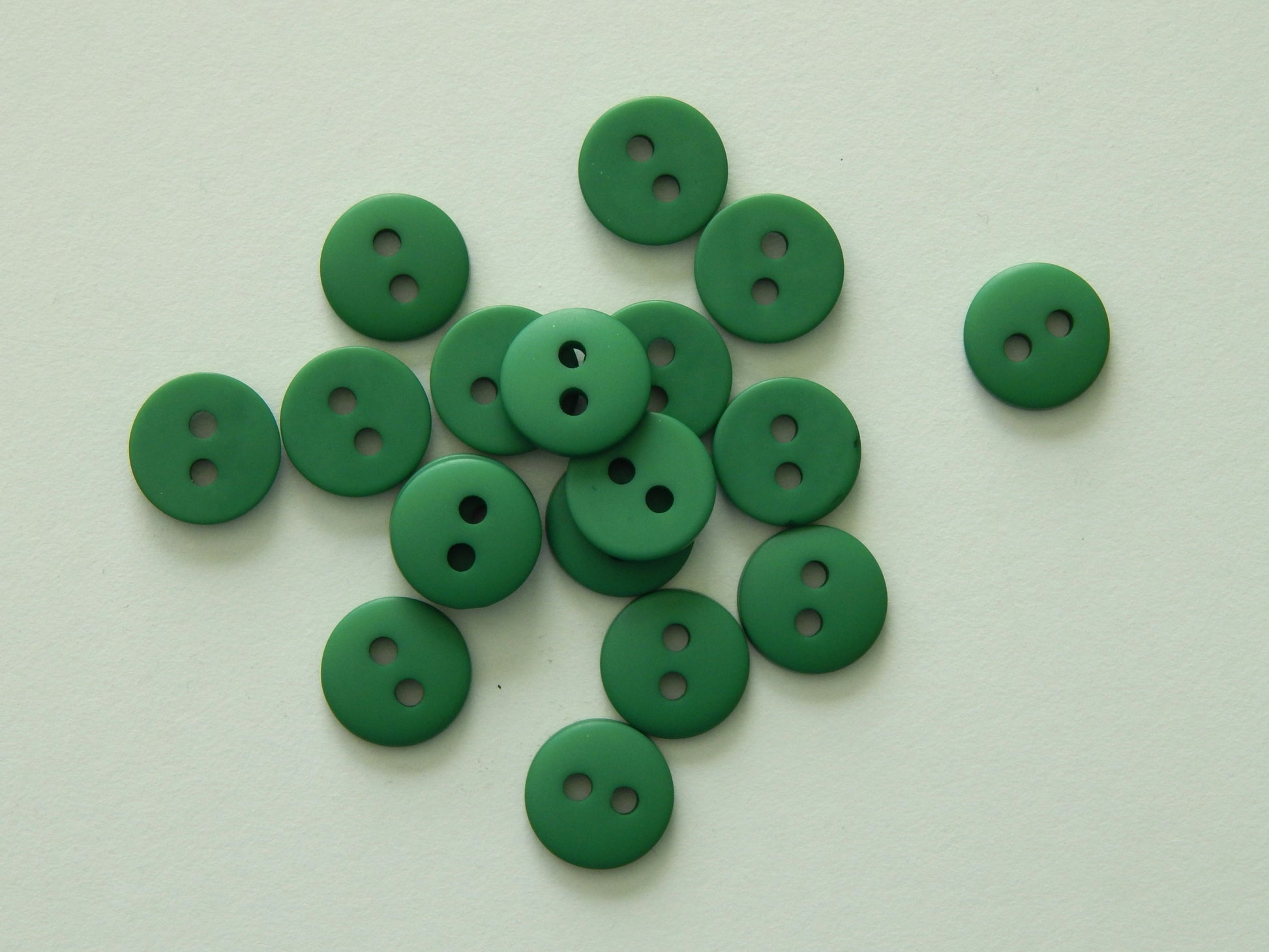 green plastic shirting buttons