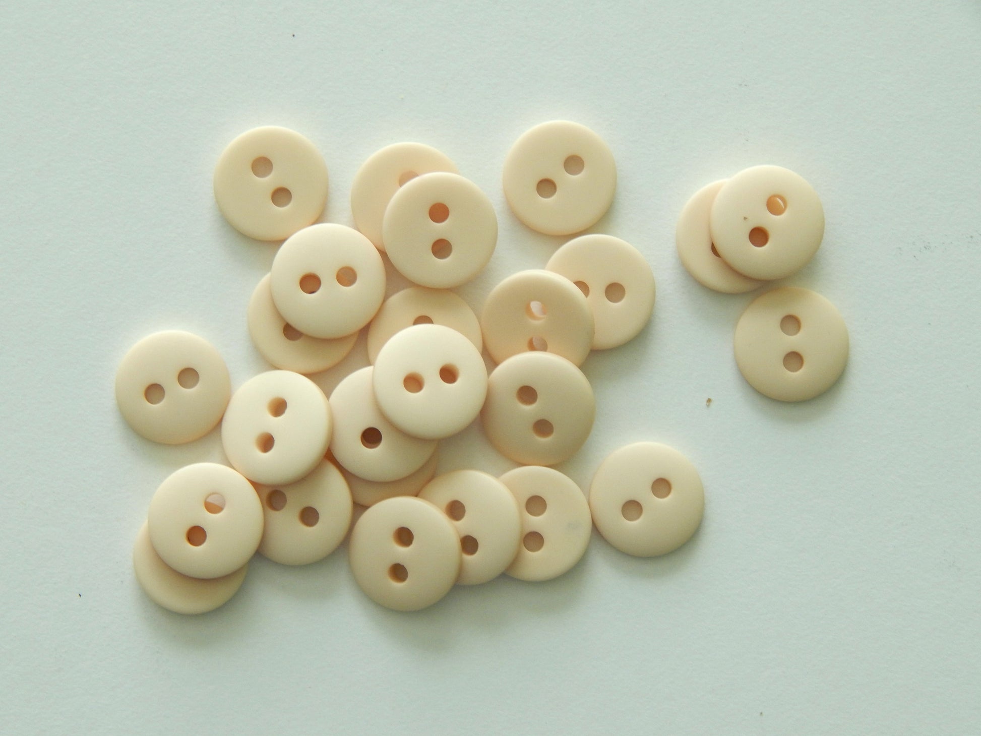 cream plastic button