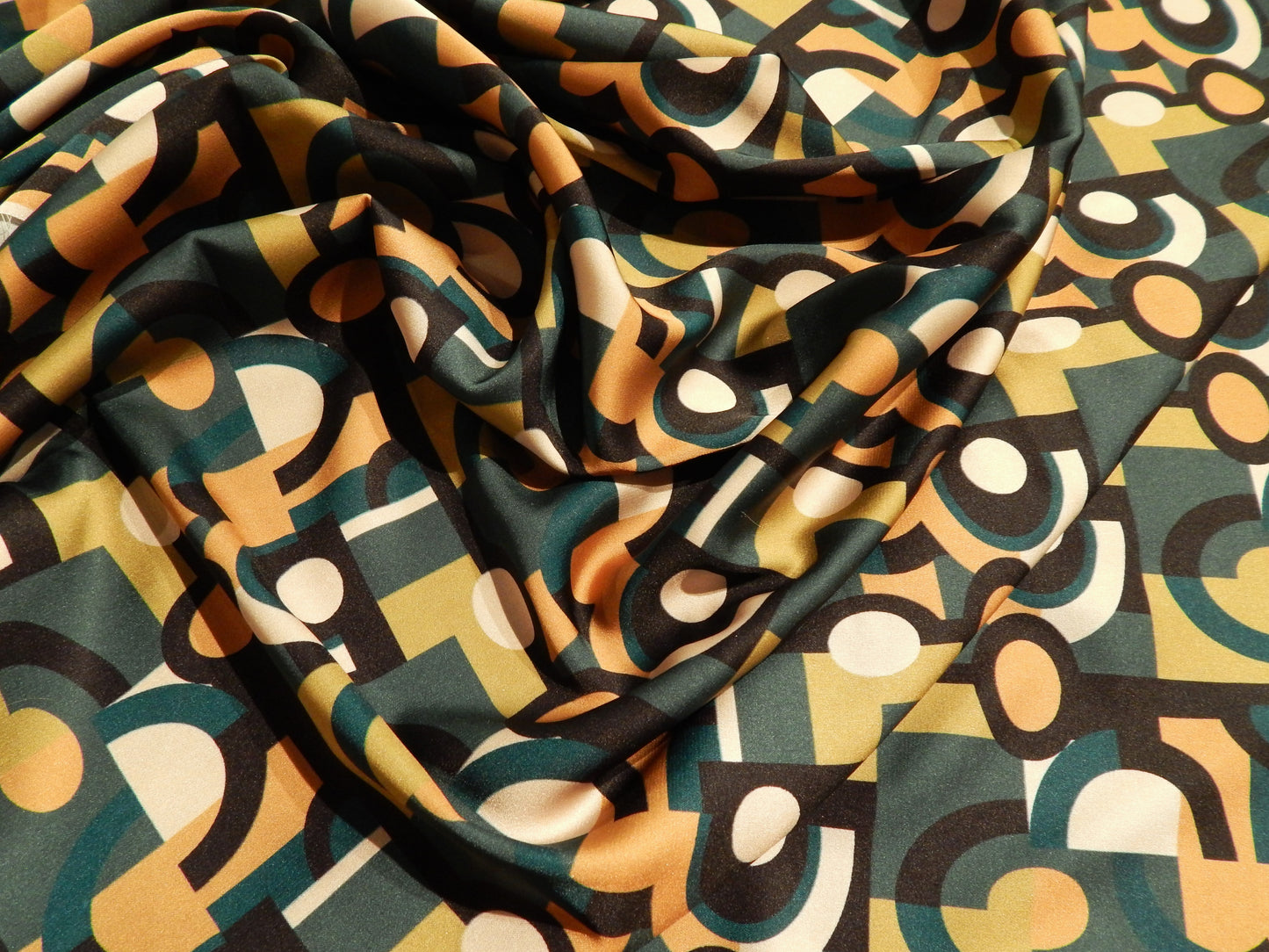 green and tan and black art deco fabric