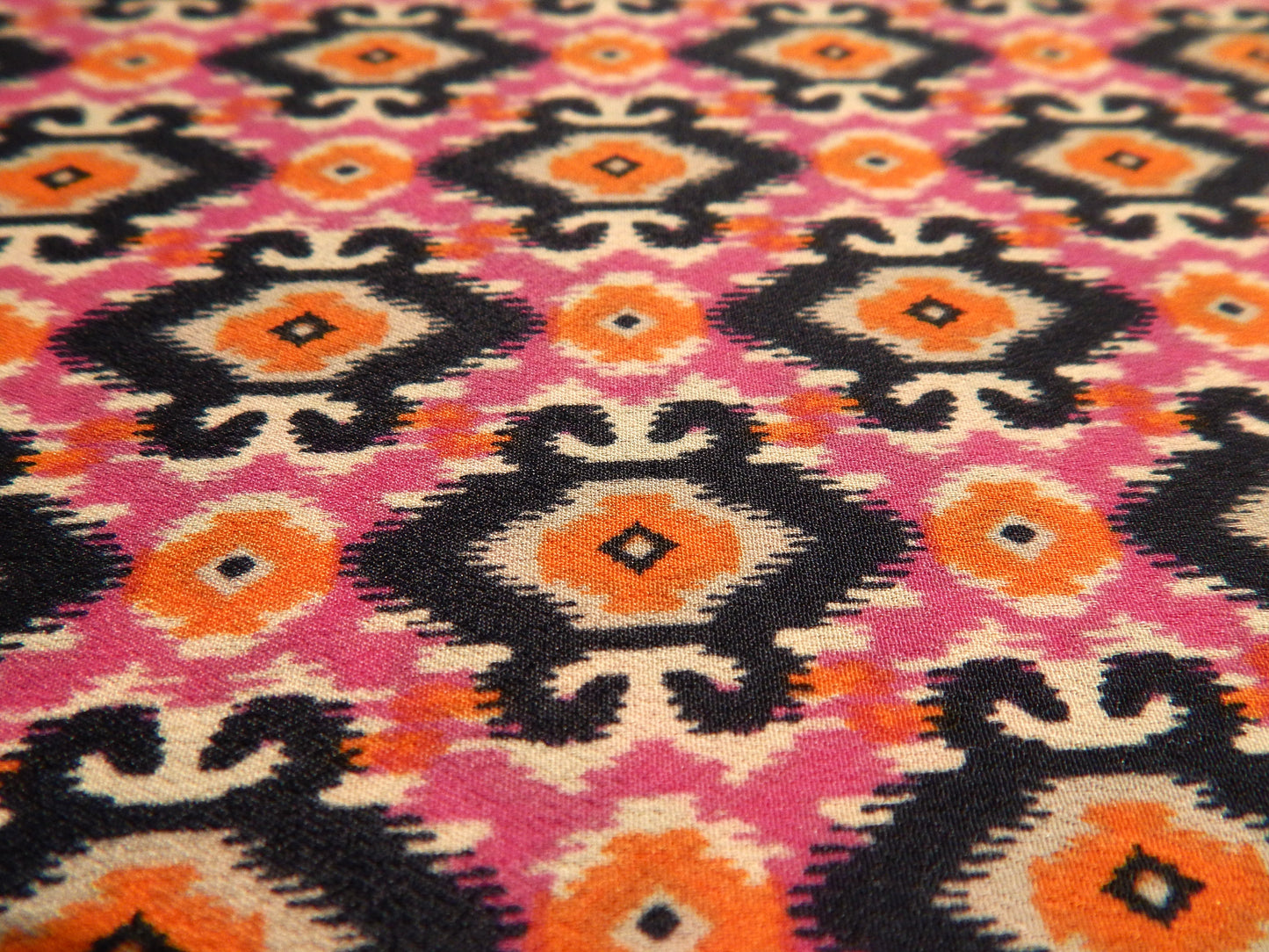 dark navy orange and hot pink ikat small motif fabric