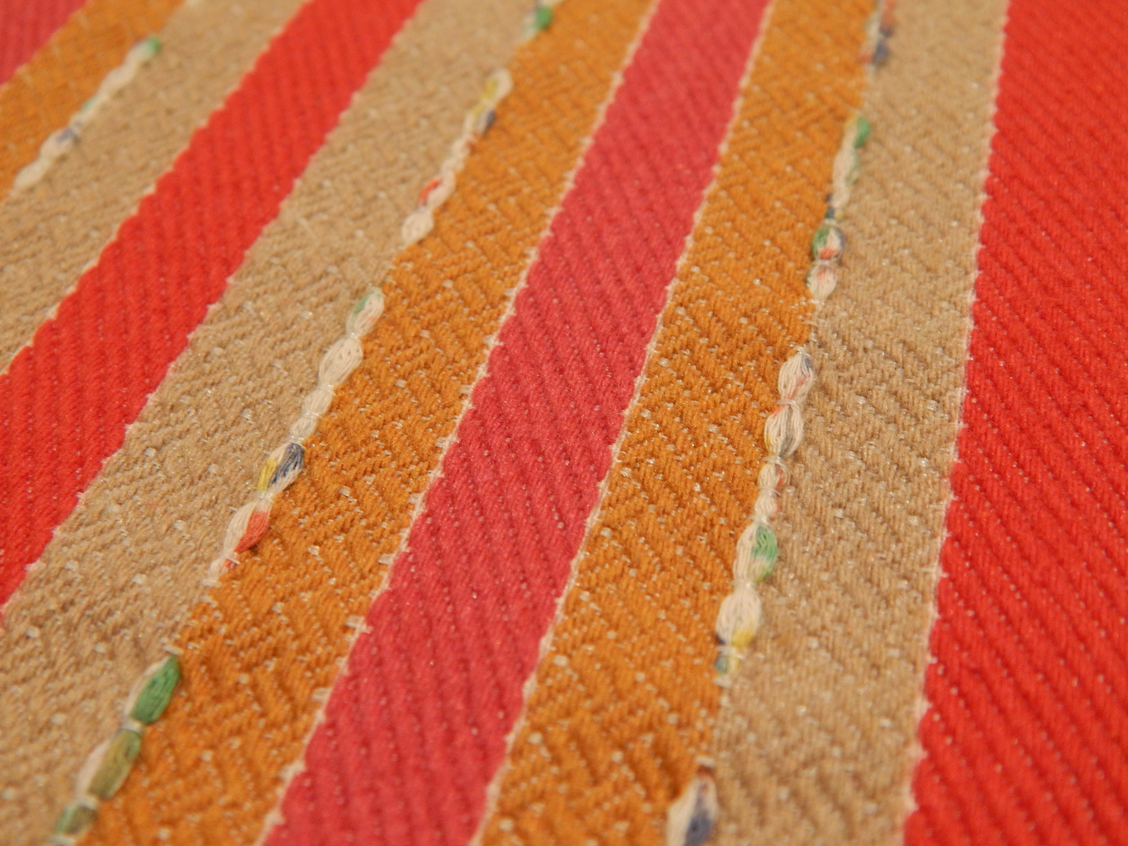 red orange and tan moray stripe yarn couched fabric